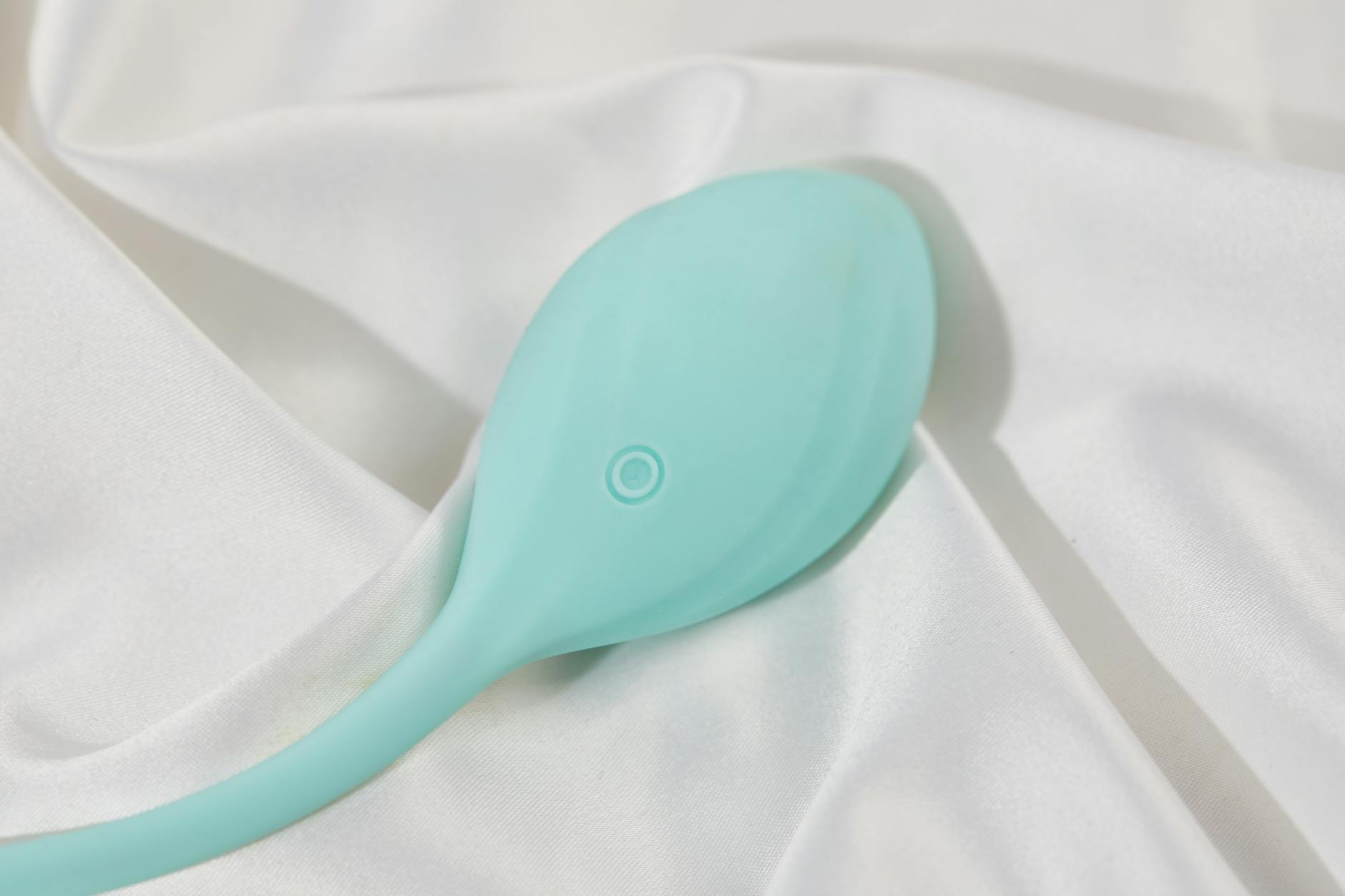 Hand exploring colorful adult wellness toys on a table