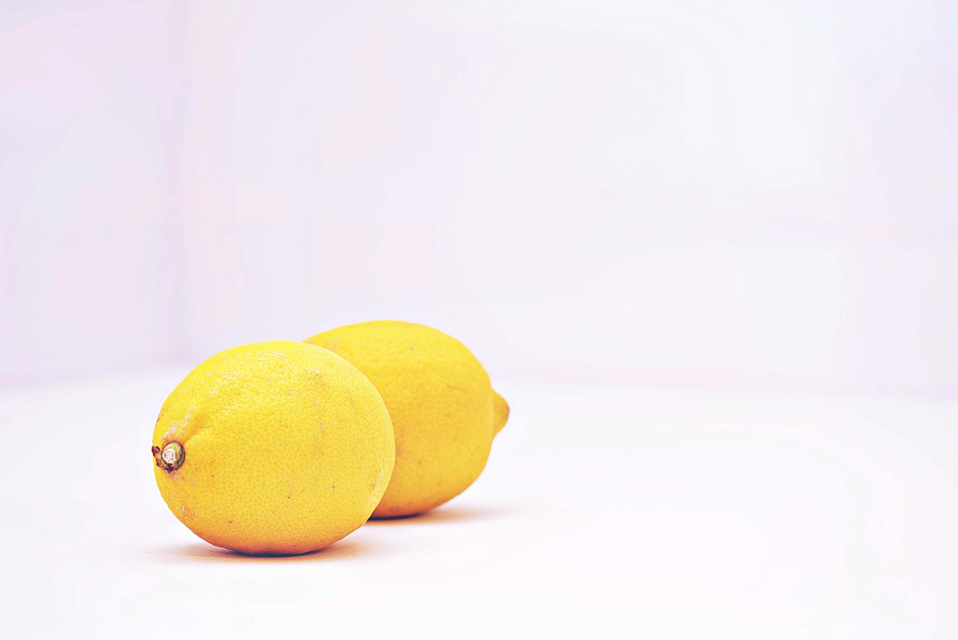 Two vibrant lemons symbolizing the cyclical changes in clitoral sensitivity and pleasure throughout the menstrual cycle