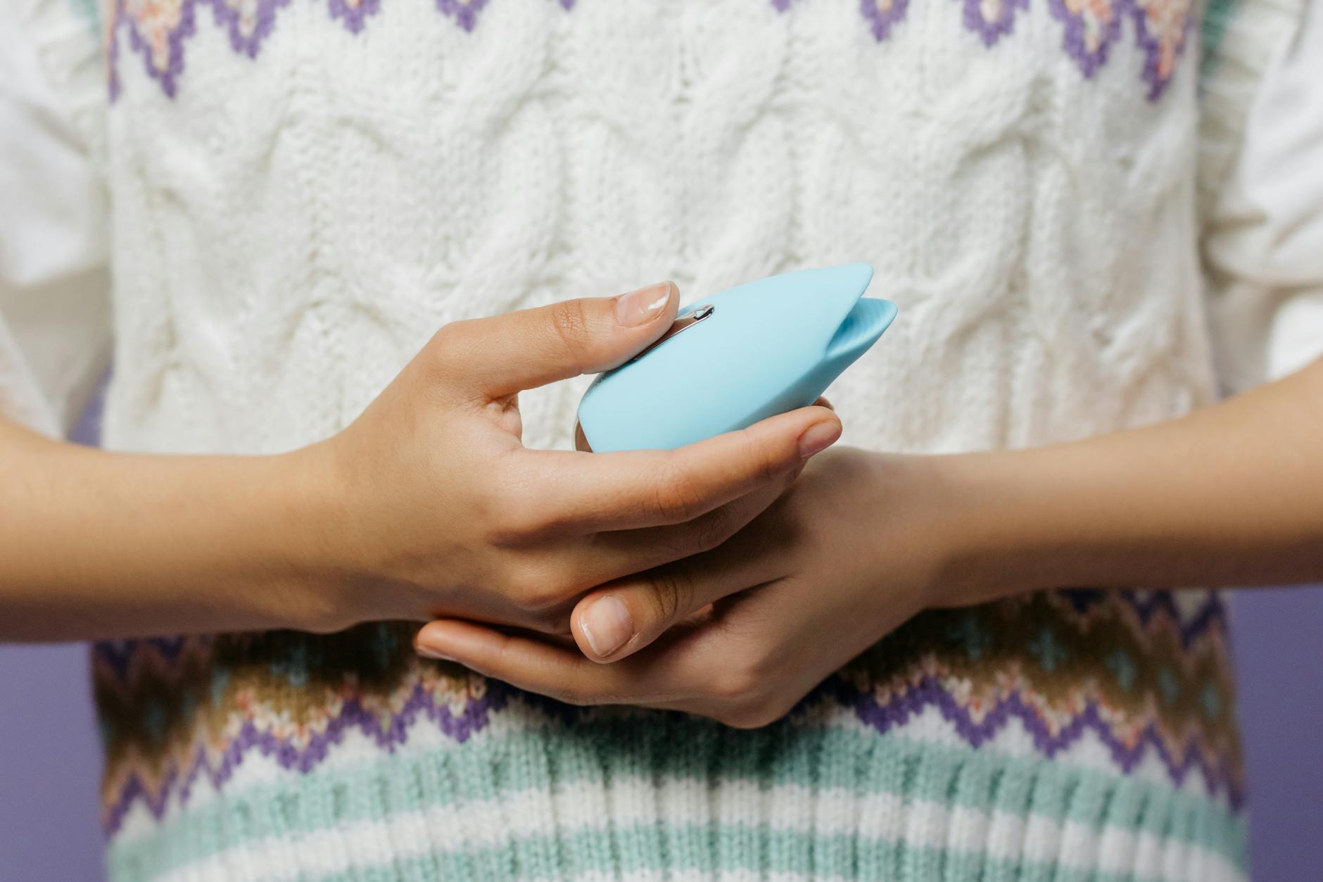 Hands holding a lemon clitoral vibrator together during intimate time