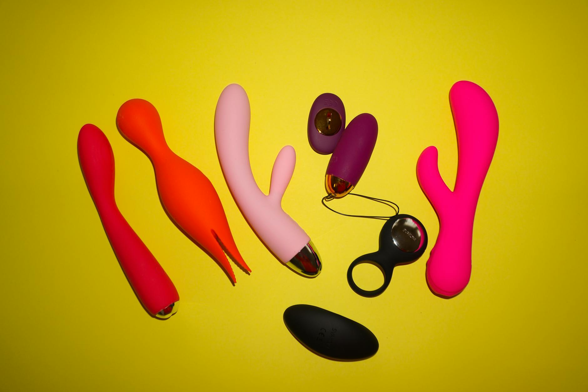 Blue silicone lemon vibrator held in hand against purple background