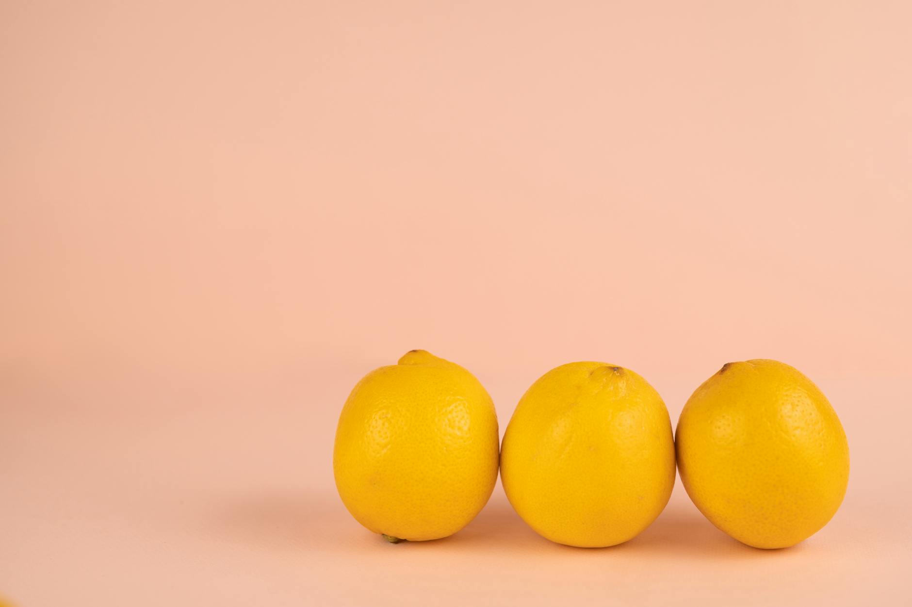 Bright fresh lemons on a pastel background, symbolizing renewed vitality after postpartum recovery